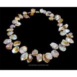 A Natural 15-18 mm Reborn Keshi Petal Pearl necklace with 14 carat gold clasp.