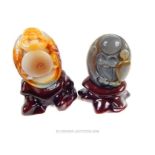 Two Chinese agate Buddhist figures, on stands