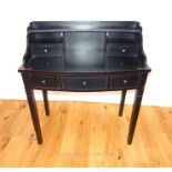 A contemporary ebonised desk