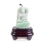 A Chinese carved jade Buddhist figure on stand