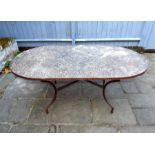 A garden table with a moulded mosaic style top