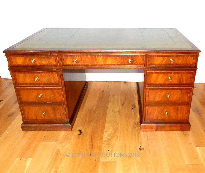 A mahogany and cross banded pedestal desk