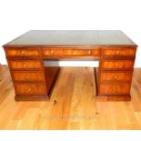 A mahogany and cross banded pedestal desk