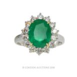 An Emerald and Diamond Cluster Ring.