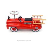 A red painted metal child's ride on fire engine .