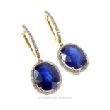 A Pair of Sapphire and Diamond Halo Post Drop Earrings.