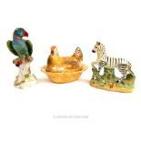 A Staffordshire Zebra, Meissen style parrot and chicken tureen with cover