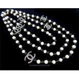 A Long Set of Cultured Freshwater Pearl and Black Glass Necklace.