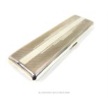 An Art Deco Sterling Silver Elongated Cigarette Case.