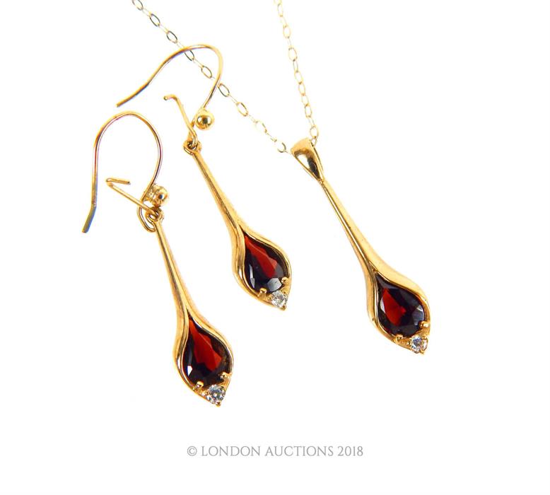 A Vintage 9 ct gold Garnet and Diamond pear drop pendant necklace and matching earrings.