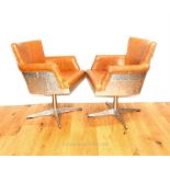A pair of Aviator style aluminium swivel chairs