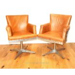 A pair of Aviator style aluminium swivel chairs