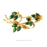 A 14ct yellow gold brooch set with emerald cabochons