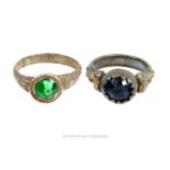 Two antique white metal rings set with green glass