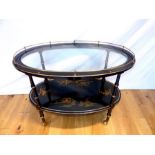 A mid 20th Century Chinese black lacquered oval drinks trolley