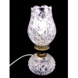 A table lamp with a crystal shade and base