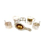 Four sterling silver cup holders and a tea strainer