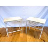 A pair of white painted metal low tables with marble tops