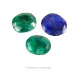 Two faceted green gemstones and a faceted blue gemstone