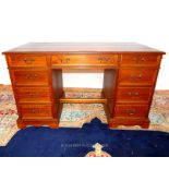 A teak pedestal desk