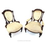 A pair of late Victorian carved walnut gentlemen and ladies chairs