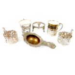 Four sterling silver cup holders and a tea strainer