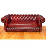 A red leather Chesterfield sofa