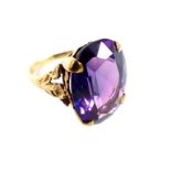 A large, 9 ct yellow gold, large, purple-corundum ring