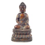 A Tibetan bronzed metal seated Buddha