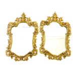 A pair of Rococo style gilt brass wall mirrors