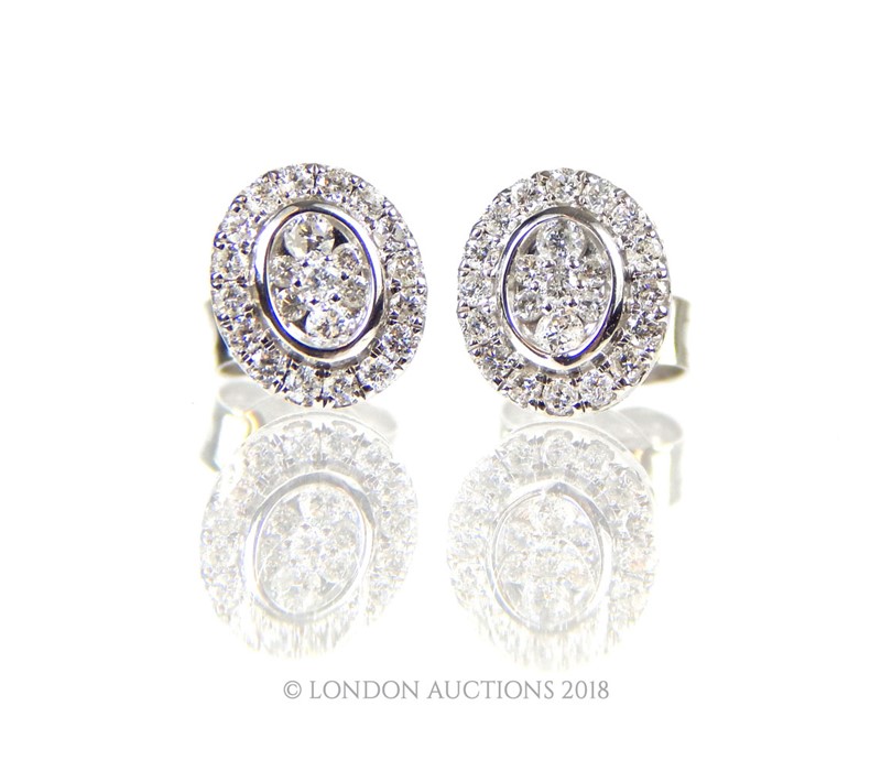 A Pair of White Gold and Diamond Stud Earrings.