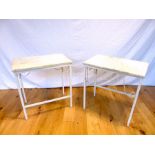 A pair of white painted metal low tables with marble tops