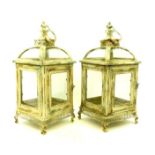 A pair of French-style, cream-painted metal garden lanterns