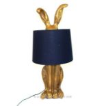 A gilt resin table lamp in the form of a rabbit