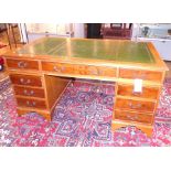 A pedestal desk with yew wood drawers