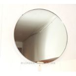 A contemporary circular mirror with a silvered frame