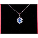 An 18 Carat White Gold Sapphire and Diamond Pendant Necklace on gold chain