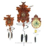 Two Cuckoo clocks and another