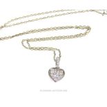 An 18 Carat White Gold and Diamond Set Pendant Necklace on a gold chain.