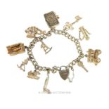 A sterling silver bracelet with silver and white metal charms