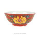 A Chinese famille rose porcelain bowl with a coral coloured ground