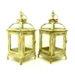 A pair of French-style, cream-painted metal storm lanterns