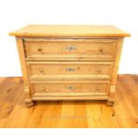 A Continental pine chest of three long drawers