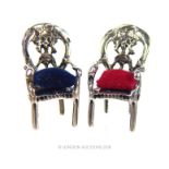 A pair of sterling silver miniature open armchairs