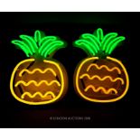 A pair of contemporary neon pineapple wall lights