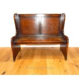 A small mid 20th century oak settle