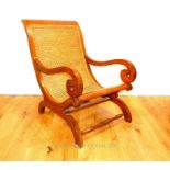 A teak and caned Colonial chair