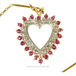 A Yellow Gold Diamond and Ruby Heart Shaped Pendant Necklace.