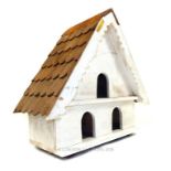 A large a-shaped bird house.