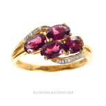 9 Carat gold oval set Garnet cross over ring with Diamond shoulder